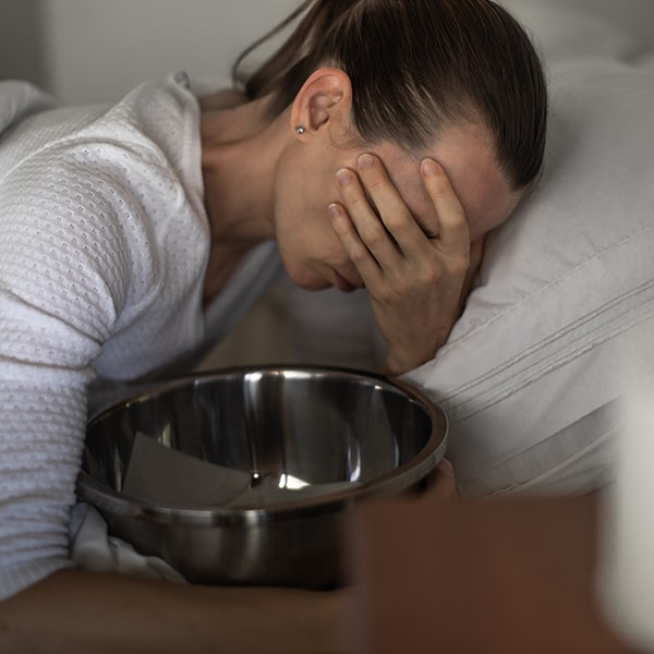 Female suffers from nausea and vomiting due to digestive and stomach illness problems and gastrointestinal system diseases or food poisoning. Morning sickness in first trimester of pregnancy